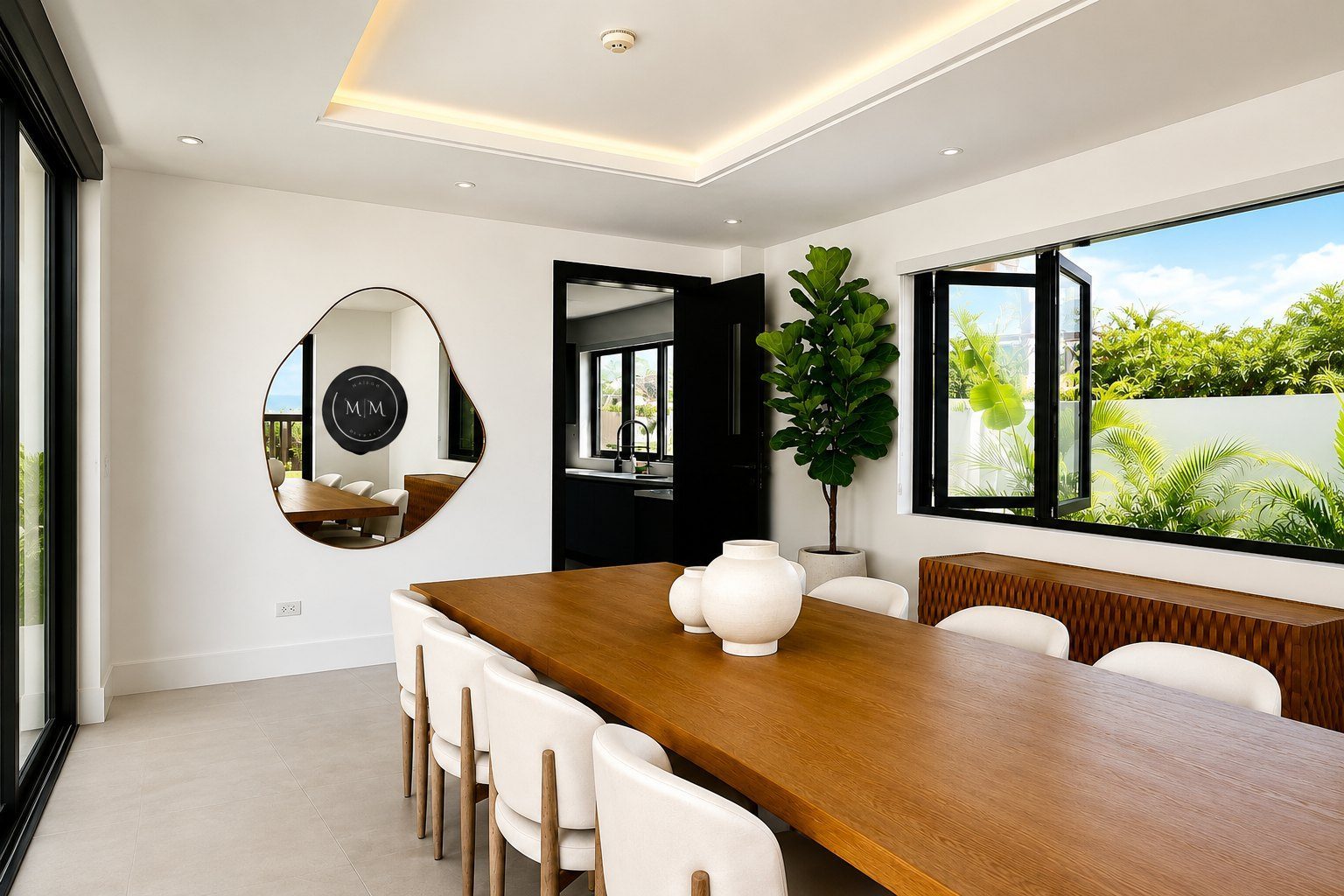 A handmade Mahoe mirror in a sunlit Jamaica dining room